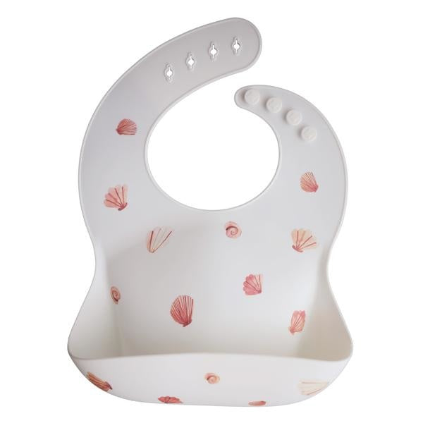 Mushie baveta cu buzunar din silicon 12m+, Shells Light